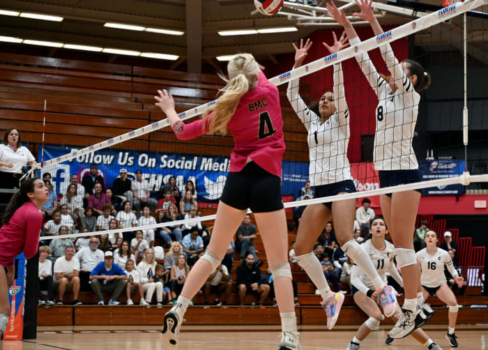 Gulliver Prep players Jackie Taylor (1) and Kate Welty (8) block a shot from Bishop Moore’s Avery Schwieger (4) during the Class 3A state championship match at the FHSAA Finals at Polk State College Saturday in Winter Haven.